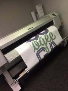 A Mutoh Value-Jet Printing perforated vinyl with the phrase $5000 Muskogee Mega Money
