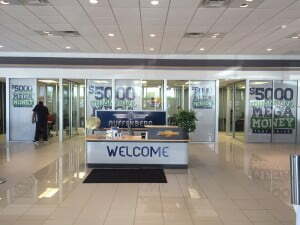 Window with perforated vinyl with the phrase "Welcome."