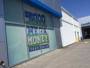 Window with perforated vinyl with the phrase $5000 Muskogee Mega Money